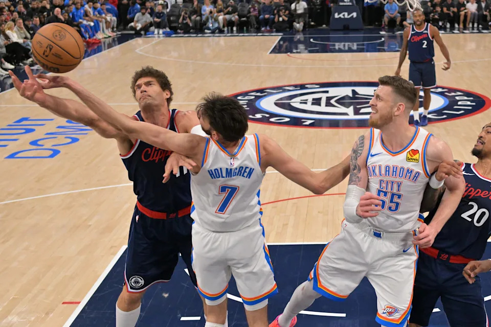 Apr 8, 2026; Inglewood, California, USA; Oklahoma City Thunder center Chet Holmgren (7), center Isaiah Hartenstein (55) and Los Angeles Clippers center Brook Lopez (11) reach for a rebound in the first half at Intuit Dome. Mandatory Credit: Jayne Kamin-Oncea-Imagn Images