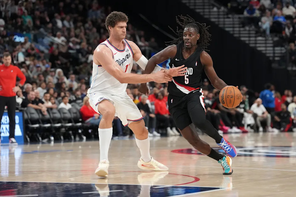 Mar 31, 2026; Inglewood, California, USA; Portland Trail Blazers guard Jrue Holiday (5) dribbles against LA Clippers center Brook Lopez (11) in the second half at Intuit Dome. Mandatory Credit: Kirby Lee-Imagn Images