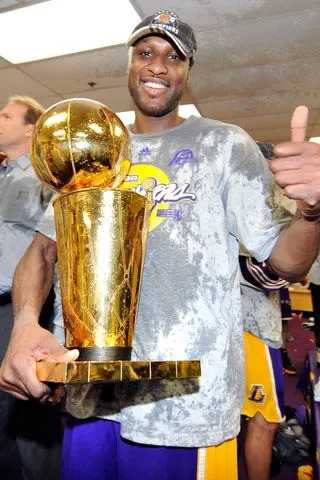 Lamar Odom #7 of the Los Angeles Lakers celebrates with the Larry O'Brien Championship trophy after the 2009 NBA Finals on June 14, 2009 in Orlando, Florida.Credit: Jesse D. Garrabrant/NBAE via Getty
