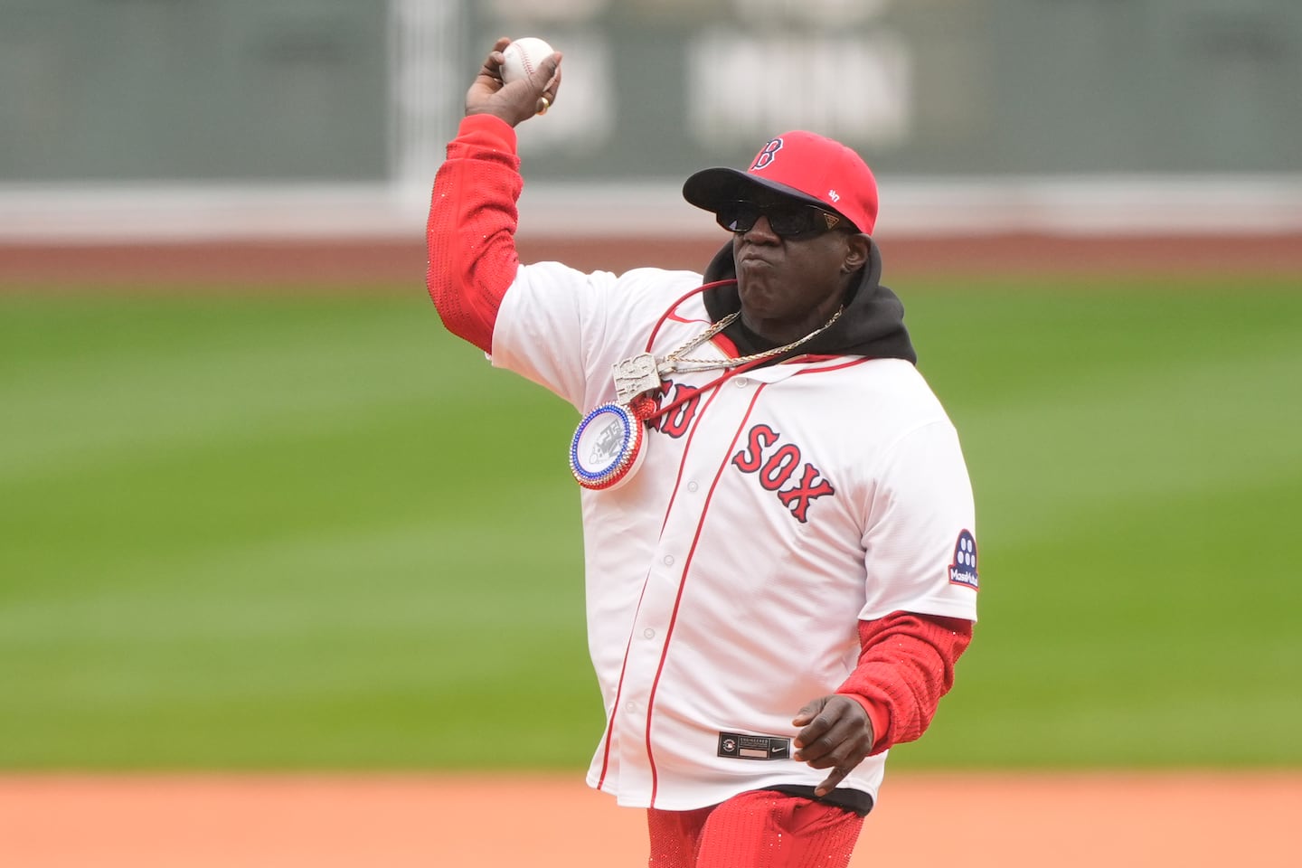Rapper Flavor Flav threw out the first pitch before a baseball game between the Boston Red Sox and the San Diego Padres, Sunday, in Boston.
