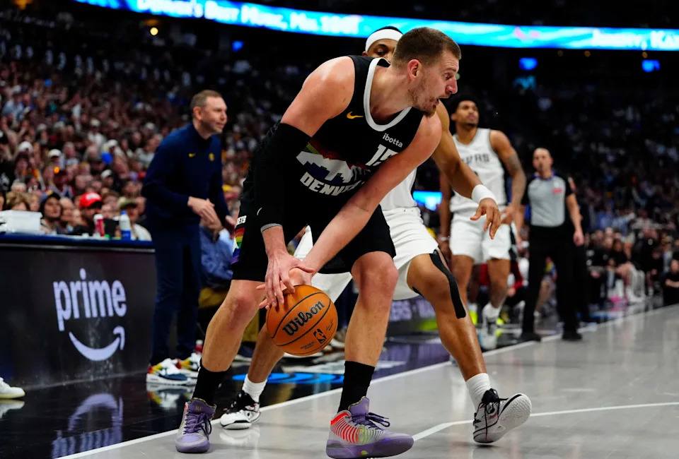 Apr 4, 2026; Denver, Colorado, USA; Denver Nuggets center Nikola Jokic (15) grabs a loose ball in the fourth quarter against the San Antonio Spurs at Ball Arena. Mandatory Credit: Ron Chenoy-Imagn Images