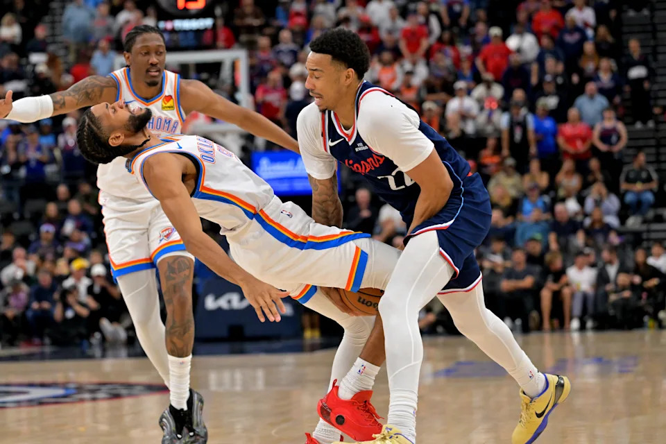 Apr 8, 2026; Inglewood, California, USA; Los Angeles Clippers guard Jordan Miller (22) is fouled by Oklahoma City Thunder guard Isaiah Joe (11) as he drives to the basket in the first half at Intuit Dome. Mandatory Credit: Jayne Kamin-Oncea-Imagn Images