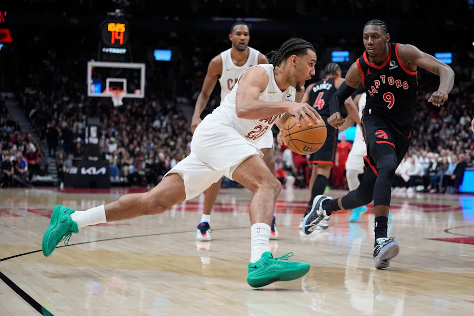 Cleveland Cavaliers forward Jaylon Tyson drives to the basket as Toronto Raptors forward RJ Barrett (9) defends during Game 3 of an NBA Playoffs first-round series April 23, 2026, in Toronto, Ontario.