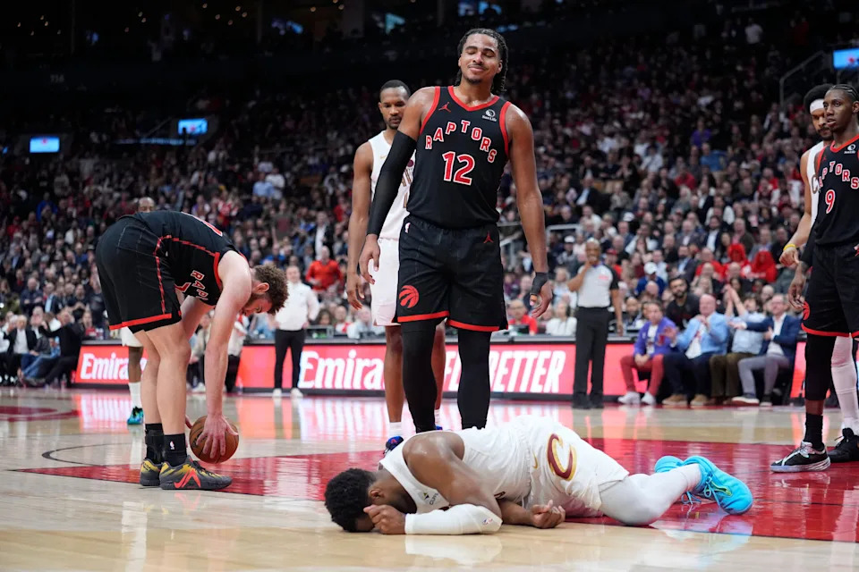 Toronto Raptors forward Collin Murray-Boyles (12) reacts after a collision with Cleveland Cavaliers guard Donovan Mitchell (45) left Mitchell on the floor during Game 3 of an NBA playoffs first-round series April 23, 2026, in Toronto, Ontario.