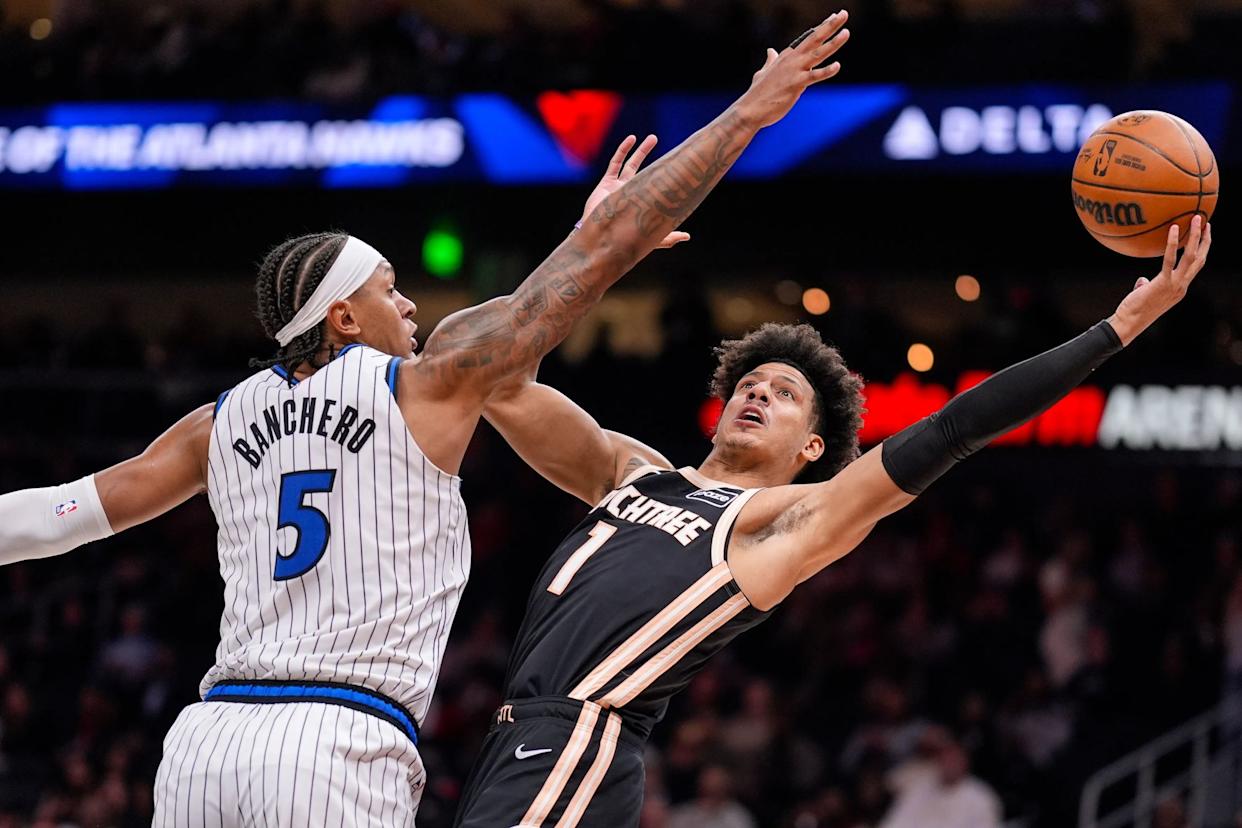 An image collage containing 1 images, Image 1 shows Atlanta Hawks forward Jalen Johnson (1) shoots against Orlando Magic forward Paolo Banchero (5)