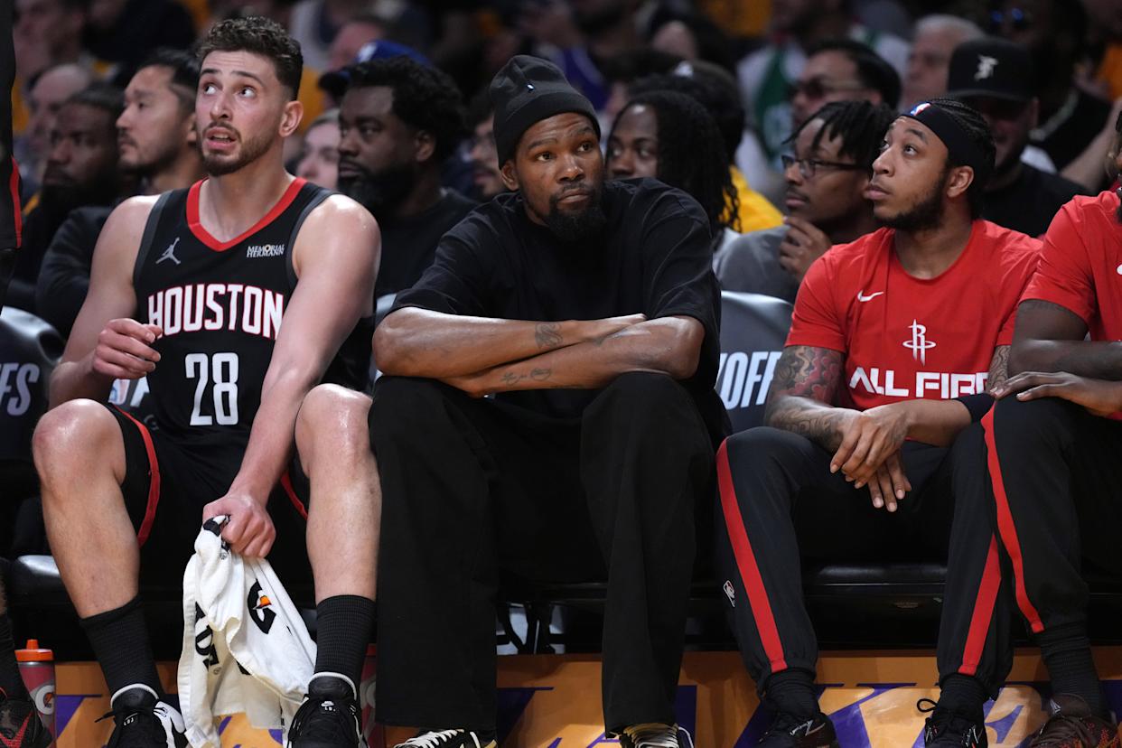 Apr 18, 2026; Los Angeles, California, USA; Houston Rockets center Alperen Sengun (28) and forward Kevin Durant (center) watch during the first half against the Los Angeles Lakers during game...