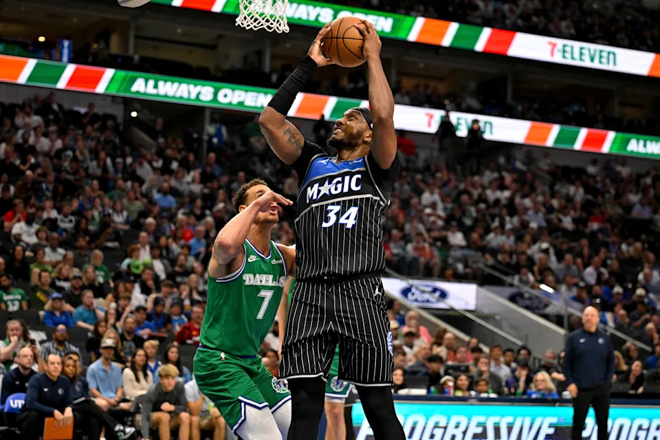 Apr 3, 2026; Dallas, Texas, USA; Orlando Magic center Wendell Carter Jr. (34) shoots the ball over Dallas Mavericks forward Dwight Powell (7) during the second half at the American Airlines Center. Mandatory Credit: Jerome Miron-Imagn Images