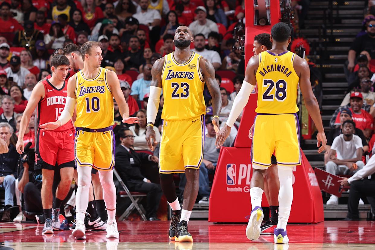 LeBron James, Luke Kennard, and Rui Hachimura of the Los Angeles Lakers look on during a game against the Houston Rockets.