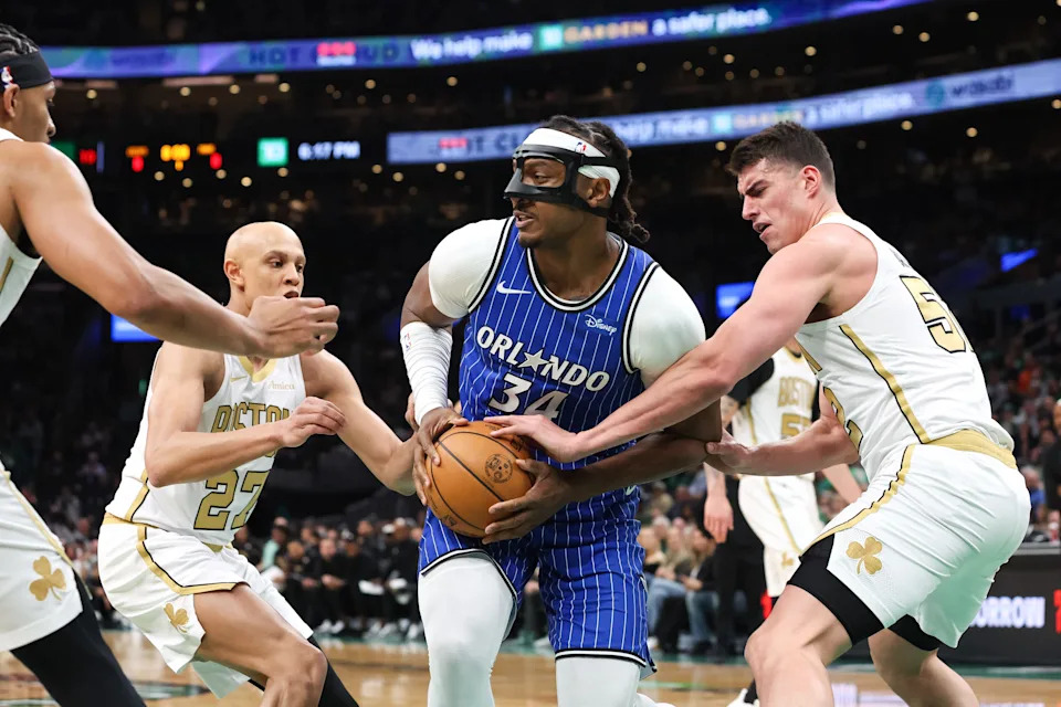 Apr 12, 2026; Boston, Massachusetts, USA; Boston Celtics forward Luka Garza (52) defends Orlando Magic center Wendell Carter Jr (34) during the first half at TD Garden. Mandatory Credit: Paul Rutherford-Imagn Images