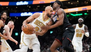 Boston Celtics guard Derrick White (9) is defended by Philadelphia 76ers guard VJ Edgecombe (77) during the first half of an NBA basketball game, Sunday, March 1, 2026, in Boston.