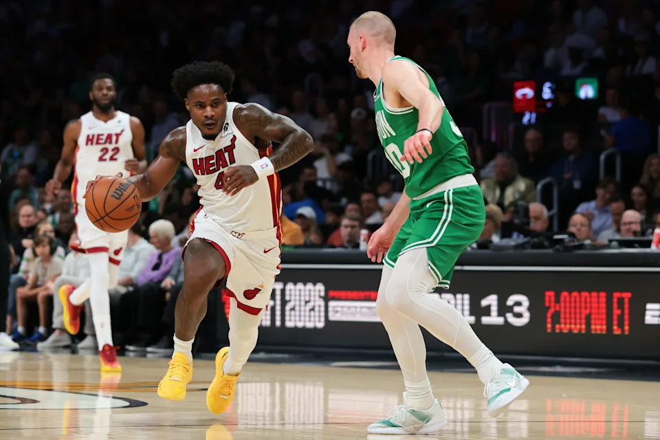 Apr 1, 2026; Miami, Florida, USA; Miami Heat guard Davion Mitchell (45) drives to the basket against Boston Celtics forward Sam Hauser (30) during the first quarter at Kaseya Center. Mandatory Credit: Sam Navarro-Imagn Images