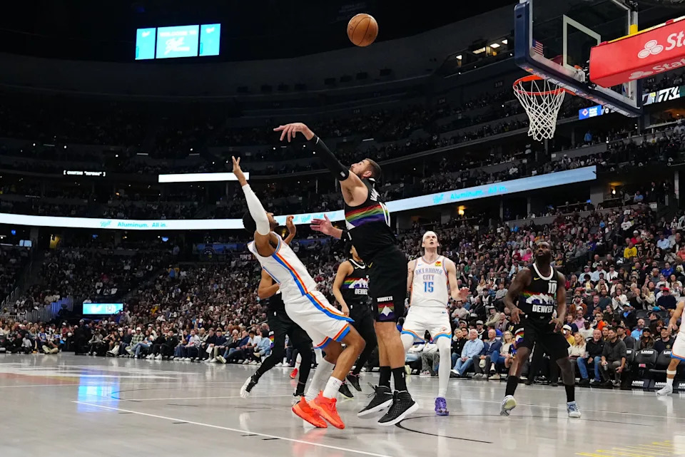 Apr 10, 2026; Denver, Colorado, USA; Oklahoma City Thunder guard Aaron Wiggins (21) shoots over Denver Nuggets center Jonas Valanciunas (17) in the first quarter at Ball Arena. Mandatory Credit: Ron Chenoy-Imagn Images