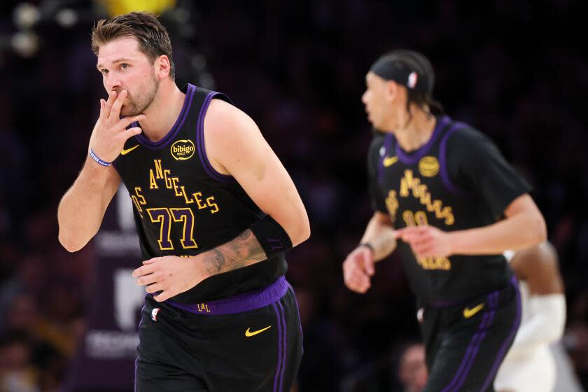 Los Angeles, CA - March 31: Lakers guard Luka Doncic, #77 reacts after making.