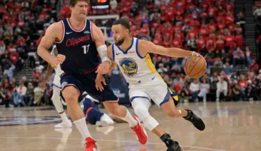 Los Angeles Clippers center Brook Lopez defends Golden State Warriors guard Stephen Curry in the second half at Intuit Dome.