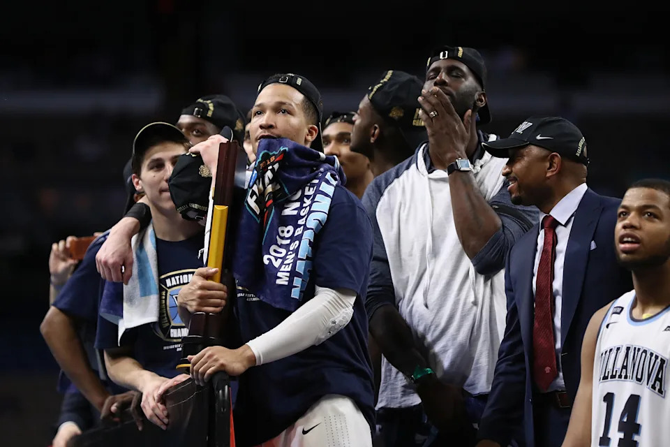 SAN ANTONIO, TX - APRIL 02:  Collin Gillespie #2 and Jalen Brunson #1 of the Villanova Wildcats watch "One Shining Moment" while celebrating after defeating the Michigan Wolverines during the 2018 NCAA Men's Final Four National Championship game at the Alamodome on April 2, 2018 in San Antonio, Texas. Villanova defeated Michigan 79-62.  (Photo by Ronald Martinez/Getty Images)