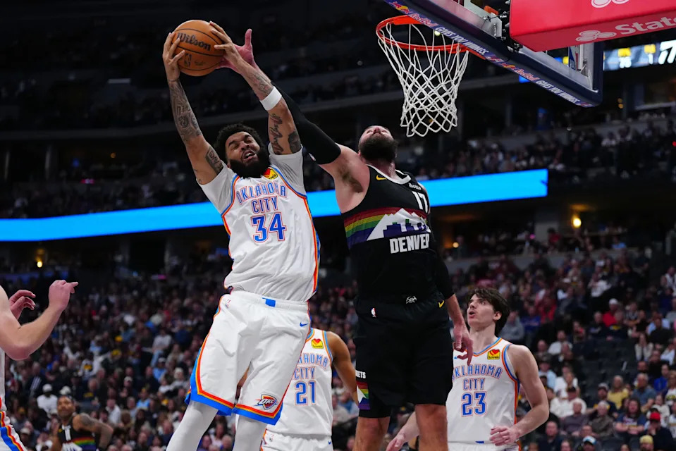 Apr 10, 2026; Denver, Colorado, USA; Oklahoma City Thunder guard Kenrich Williams (34) and Denver Nuggets center Jonas Valanciunas (17) reach for a rebound in the second half at Ball Arena. Mandatory Credit: Ron Chenoy-Imagn Images