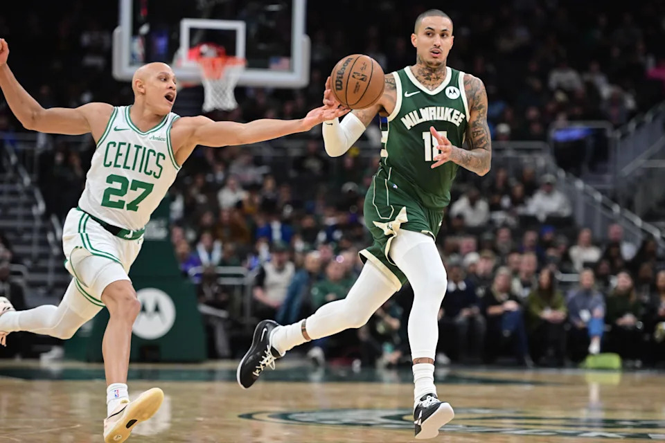 Dec 11, 2025; Milwaukee, Wisconsin, USA; Boston Celtics forward Jordan Walsh (27) tries to steal the ball from Milwaukee Bucks forward Kyle Kuzma (18) in the second quarter at Fiserv Forum. Mandatory Credit: Benny Sieu-Imagn Images
