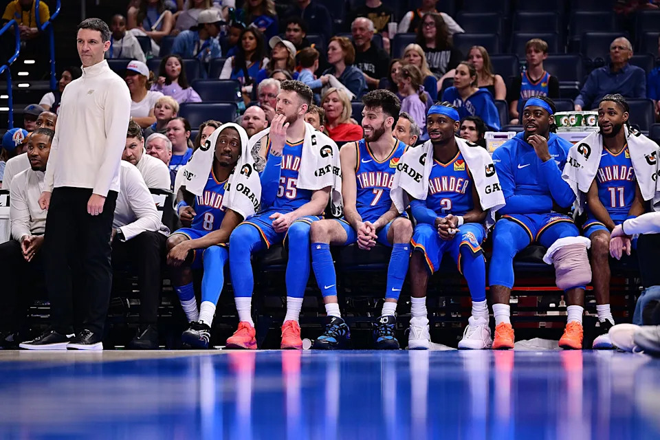 OKLAHOMA CITY, OKLAHOMA - APRIL 5: Head coach Mark Daigneault, Jalen Williams #8, Isaiah Hartenstein #55, Chet Holmgren #7, Shai Gilgeous-Alexander #2, Luguentz Dort #5 and Isaiah Joe #11 of the Oklahoma City Thunder look on from the bench during the fourth quarter against the Utah Jazz at Paycom Center on April 5, 2026 in Oklahoma City, Oklahoma. NOTE TO USER: User expressly acknowledges and agrees that, by downloading and or using this photograph, User is consenting to the terms and conditions of the Getty Images License Agreement. (Photo by Joshua Gateley/Getty Images)