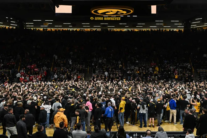 Feb 17, 2026; Iowa City, Iowa, USA; Iowa Hawkeyes fans storm the court after the game against the Nebraska Cornhuskers at Carver-Hawkeye Arena. Mandatory Credit: Jeffrey Becker-Imagn Images