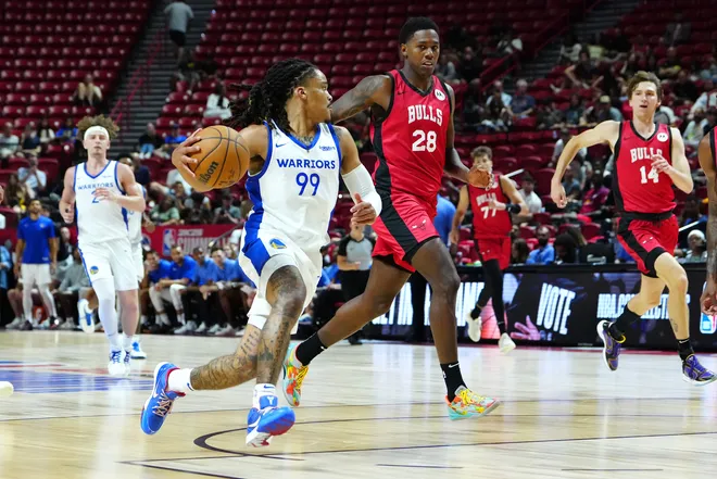 Jul 14, 2024; Las Vegas, NV, USA; Golden State Warriors guard Yuri Collins (99) dribbles around Chicago Bulls guard Chase Audige (18) during the fourth quarter at Thomas & Mack Center. Mandatory Credit: Stephen R. Sylvanie-USA TODAY Sports