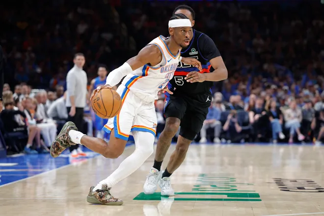 Mar 30, 2026; Oklahoma City, Oklahoma, USA; Oklahoma City Thunder guard Shai Gilgeous-Alexander (2) drives around Detroit Pistons forward Ronald Holland II (5) during the second half at Paycom Center. Mandatory Credit: Alonzo Adams-Imagn Images