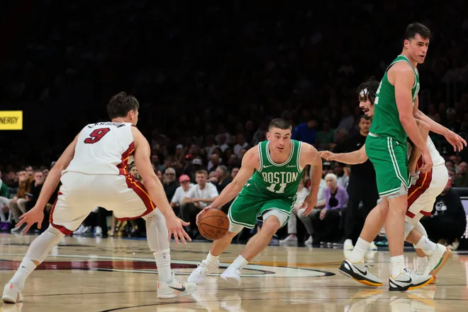Apr 1, 2026; Miami, Florida, USA; Boston Celtics guard Payton Pritchard (11) drives to the basket against Miami Heat guard Pelle Larsson (9) during the third quarter at Kaseya Center. Mandatory Credit: Sam Navarro-Imagn Images
