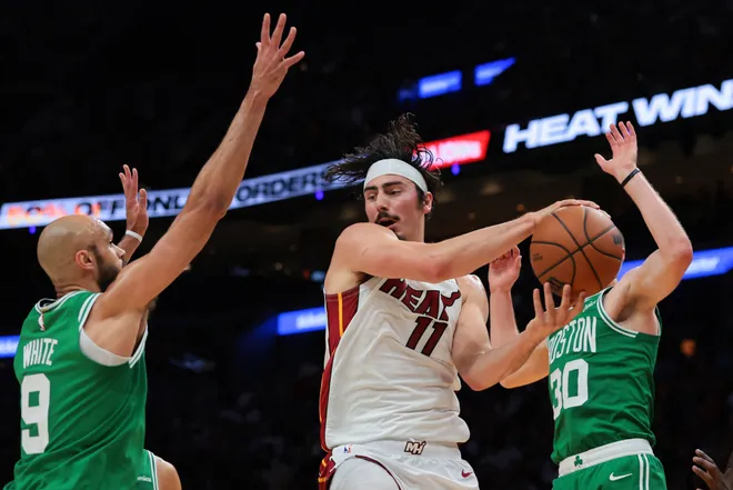Apr 1, 2026; Miami, Florida, USA; Miami Heat forward Jaime Jaquez Jr. (11) protects the basketball from Boston Celtics guard Derrick White (9) during the second quarter at Kaseya Center. Mandatory Credit: Sam Navarro-Imagn Images