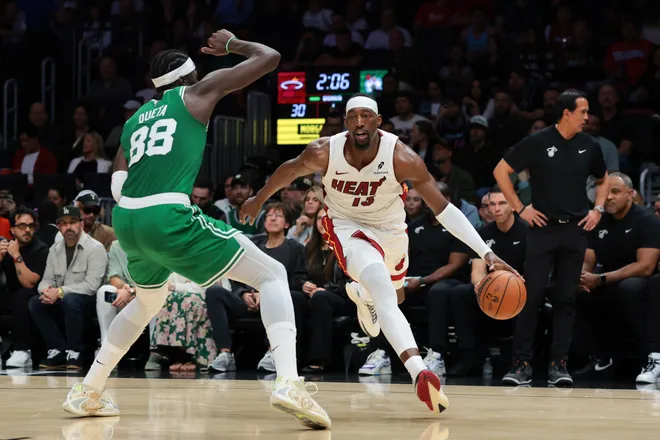 Apr 1, 2026; Miami, Florida, USA; Miami Heat center Bam Adebayo (13) drives to the basket against Boston Celtics center Neemias Queta (88) during the first quarter at Kaseya Center. Mandatory Credit: Sam Navarro-Imagn Images