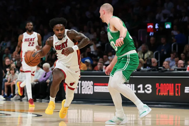 Apr 1, 2026; Miami, Florida, USA; Miami Heat guard Davion Mitchell (45) drives to the basket against Boston Celtics forward Sam Hauser (30) during the first quarter at Kaseya Center. Mandatory Credit: Sam Navarro-Imagn Images
