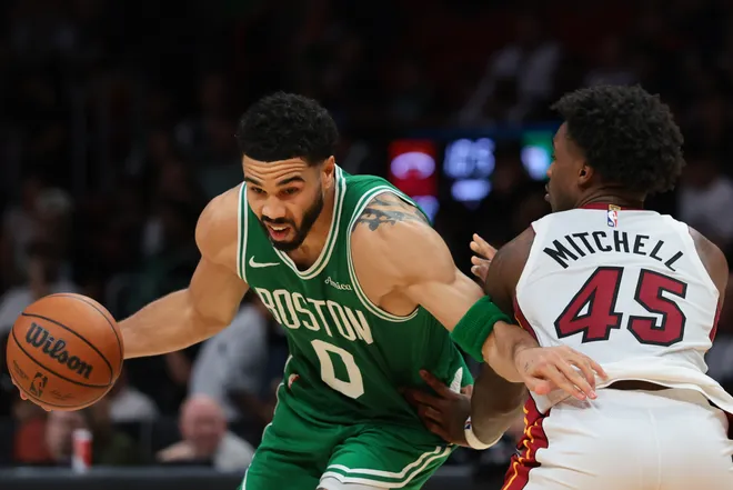 Apr 1, 2026; Miami, Florida, USA; Boston Celtics forward Jayson Tatum (0) drives to the basket against Miami Heat guard Davion Mitchell (45) during the third quarter at Kaseya Center. Mandatory Credit: Sam Navarro-Imagn Images