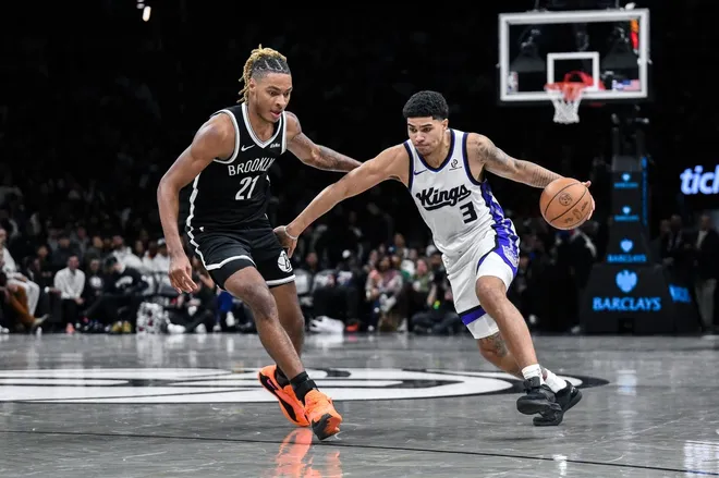 Mar 29, 2026; Brooklyn, New York, USA; Sacramento Kings guard Killian Hayes (3) drives past Brooklyn Nets forward/center Noah Clowney (21) during the second half at Barclays Center.
