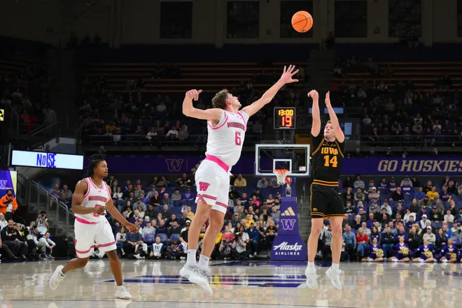 Feb 4, 2026; Seattle, Washington, USA; Iowa Hawkeyes guard Bennett Stirtz (14) shoots the ball over Washington Huskies forward Hannes Steinbach (6) during the second half at Alaska Airlines Arena at Hec Edmundson Pavilion. Mandatory Credit: Steven Bisig-Imagn Images