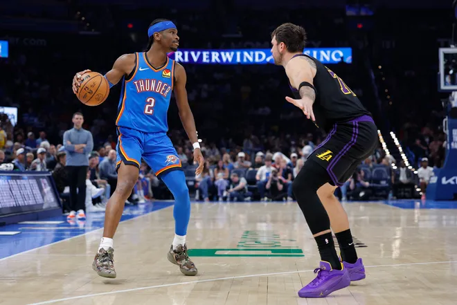 Apr 2, 2026; Oklahoma City, Oklahoma, USA; Oklahoma City Thunder guard Shai Gilgeous-Alexander (2) dribbles down the court as Los Angeles Lakers guard Luka Doncic (77) defends during the second half at Paycom Center. Mandatory Credit: Alonzo Adams-Imagn Images