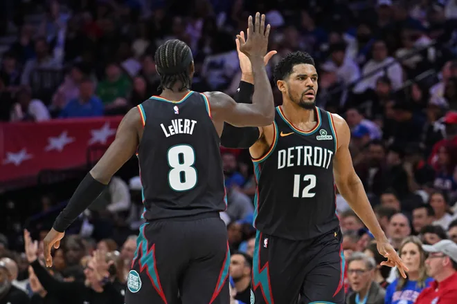 Apr 4, 2026; Philadelphia, Pennsylvania, USA; Detroit Pistons forward Tobias Harris (12) celebrates a basket with guard Caris LeVert (8) against the Philadelphia 76ers during the second half at Xfinity Mobile Arena. Mandatory Credit: Eric Hartline-Imagn Images