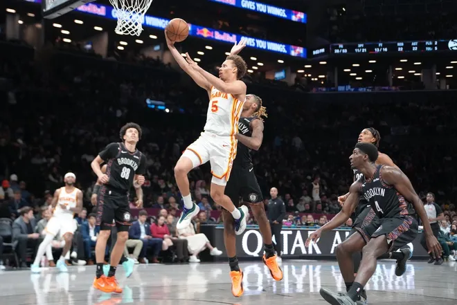 Apr 3, 2026; Brooklyn, New York, USA; Atlanta Hawks guard Dyson Daniels (5) shoots a layup against Brooklyn Nets forward Noah Clowney (21) during the second half at Barclays Center.