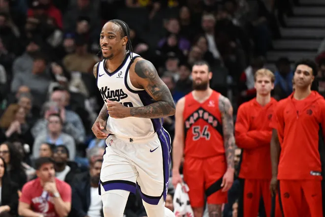 Apr 1, 2026; Toronto, Ontario, CAN; Sacramento Kings forward DeMar DeRozan (10) runs back to defend after sinking a three-point basket from in front of the Toronto Raptors bench in the second half at Scotiabank Arena. Mandatory Credit: Dan Hamilton-Imagn Images