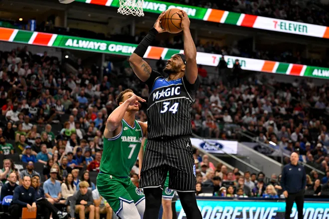 Apr 3, 2026; Dallas, Texas, USA; Orlando Magic center Wendell Carter Jr. (34) shoots the ball over Dallas Mavericks forward Dwight Powell (7) during the second half at the American Airlines Center. Mandatory Credit: Jerome Miron-Imagn Images
