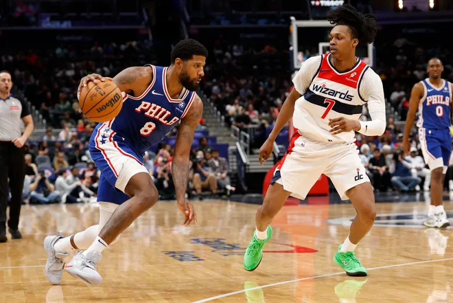 Apr 1, 2026; Washington, District of Columbia, USA; Philadelphia 76ers forward Paul George (8) drives to the basket as Washington Wizards guard Bub Carrington (7) defends in the first half at Capital One Arena. Mandatory Credit: Geoff Burke-Imagn Images