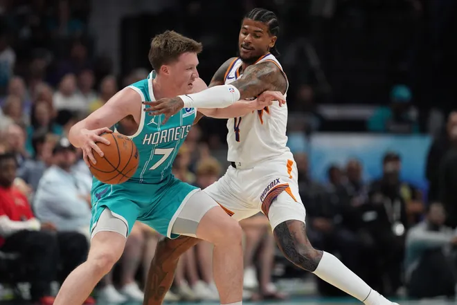 Apr 2, 2026; Charlotte, North Carolina, USA; Charlotte Hornets guard/forward Kon Knueppel (7) moves the ball defended by Phoenix Suns guard Jalen Green (4) during the first quarter at Spectrum Center. Mandatory Credit: Jim Dedmon-Imagn Images