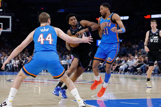 Apr 5, 2026; Oklahoma City, Oklahoma, USA; Utah Jazz forward Brice Sensabaugh (28) drives between Oklahoma City Thunder guard Nikola Topic (44) and guard Aaron Wiggins (21) during the second half at Paycom Center. Mandatory Credit: Alonzo Adams-Imagn Images