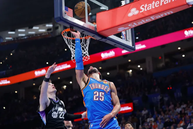 Apr 5, 2026; Oklahoma City, Oklahoma, USA; Oklahoma City Thunder guard Ajay Mitchell (25) goes up for a basket beside Utah Jazz forward Kyle Filipowski (22) during the second quarter at Paycom Center. Mandatory Credit: Alonzo Adams-Imagn Images
