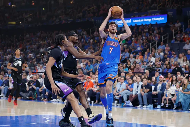 Apr 5, 2026; Oklahoma City, Oklahoma, USA; Oklahoma City Thunder center Chet Holmgren (7) drives to the basket beside Utah Jazz center Oscar Tshiebwe (34) and forward Cody Williams (5) during the first quarter at Paycom Center. Mandatory Credit: Alonzo Adams-Imagn Images