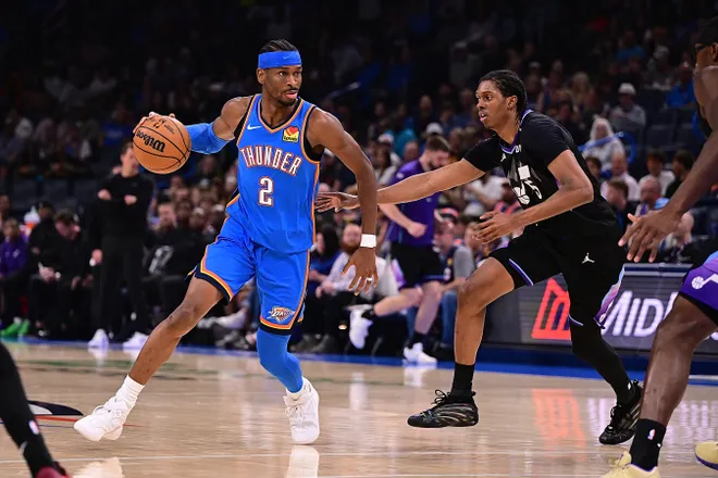 OKLAHOMA CITY, OKLAHOMA - APRIL 5: Shai Gilgeous-Alexander #2 of the Oklahoma City Thunder handles the ball against Cody Williams #5 of the Utah Jazz during the second half at Paycom Center on April 5, 2026 in Oklahoma City, Oklahoma. NOTE TO USER: User expressly acknowledges and agrees that, by downloading and or using this photograph, User is consenting to the terms and conditions of the Getty Images License Agreement. (Photo by Joshua Gateley/Getty Images)