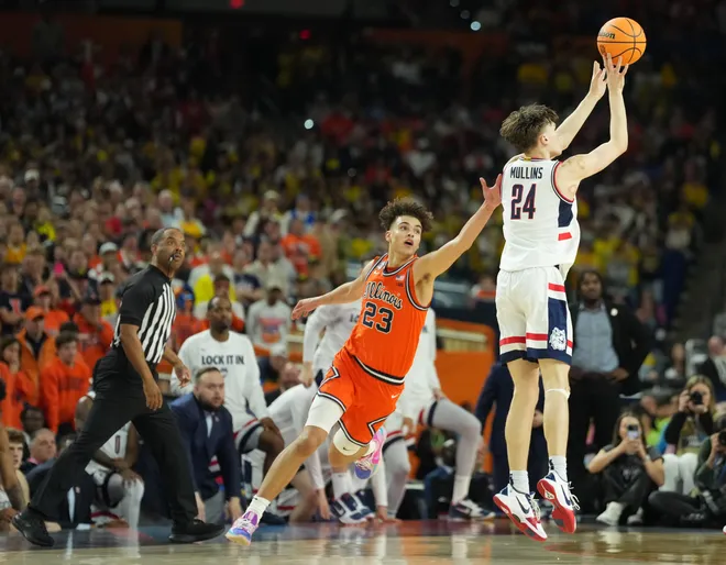 Apr 4, 2026; Indianapolis, IN, USA; Connecticut Huskies guard Braylon Mullins (24) shoots over Illinois Fighting Illini guard Keaton Wagler (23) in the second half during a semifinal of the Final Four of the men's 2026 NCAA Tournament at Lucas Oil Stadium. Mandatory Credit: Robert Deutsch-Imagn Images