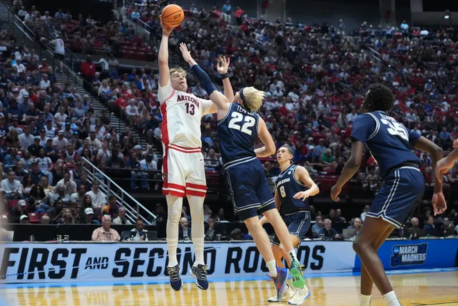 Mar 22, 2026; San Diego, CA, USA; Arizona Wildcats center Motiejus Krivas (13) shoots against Utah State Aggies forward Karson Templin (22) in the first half during a second round game of the men's 2026 NCAA Tournament at Viejas Arena. Mandatory Credit: Kirby Lee-Imagn Images