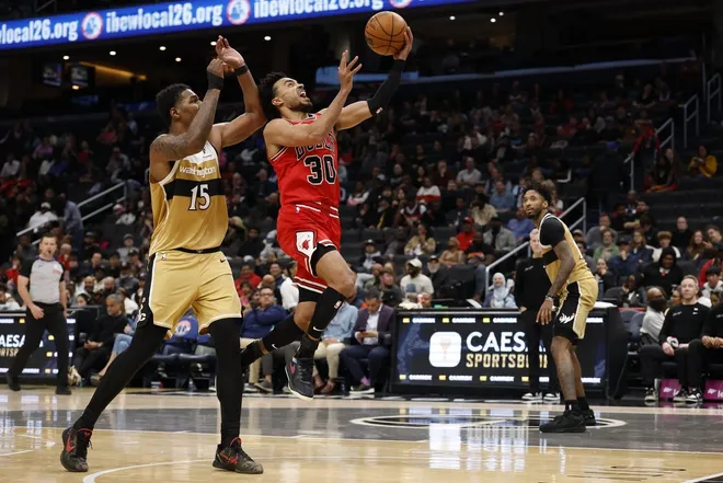 Apr 9, 2026; Washington, District of Columbia, USA; Chicago Bulls guard Tre Jones (30) shoots the ball as Washington Wizards forward Julian Reese (15) defends in the second half at Capital One Arena.