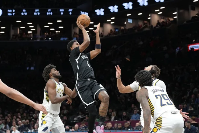 Apr 9, 2026; Brooklyn, New York, USA; Brooklyn Nets forward E.J. Liddell (9) shoots the ball against Indiana Pacers forward Jarace Walker (5) and guard Quenton Jackson (29) during the first half at Barclays Center.
