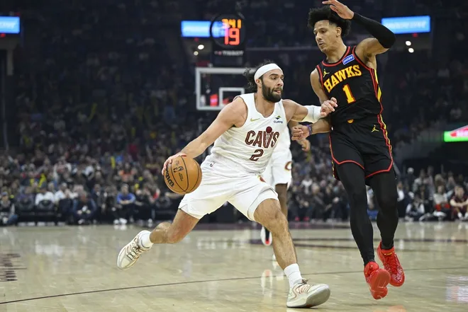 Apr 8, 2026; Cleveland, Ohio, USA; Cleveland Cavaliers guard Max Strus (2) dribbles beside Atlanta Hawks forward Jalen Johnson (1) in the third quarter at Rocket Arena.