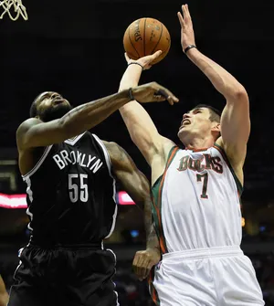 Apr 12, 2015; Milwaukee, WI, USA; Milwaukee Bucks forward Ersan Ilyasova (7) shoots the ball as Brooklyn Nets forward Earl Clark (55) defends in the third quarter at BMO Harris Bradley Center. The Bucks won 96-73. Mandatory Credit: Benny Sieu-USA TODAY Sports
