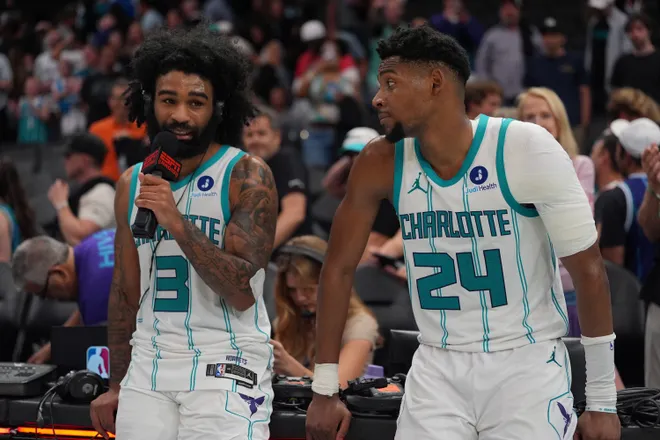 Apr 14, 2026; Charlotte, North Carolina, USA; Charlotte Hornets guard Coby White (3) alongside forward Brandon Miller (24) give an interview after the overtime win during the play-in rounds between the Charlotte Hornets and the Miami Heat of the 2026 NBA Playoffs at Spectrum Center. Mandatory Credit: Jim Dedmon-Imagn Images